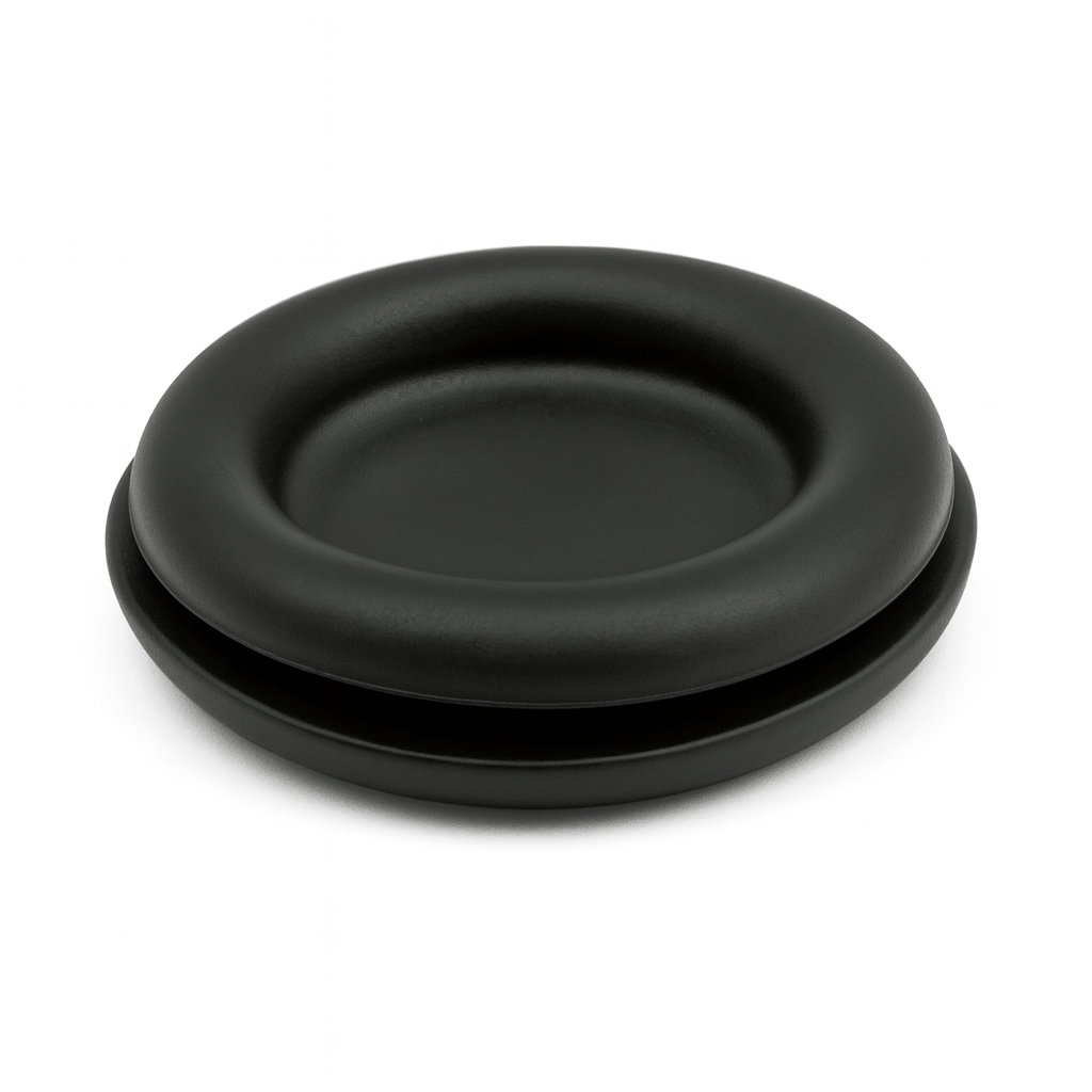 Blanking grommets installed in electrical panel sealing unused holes